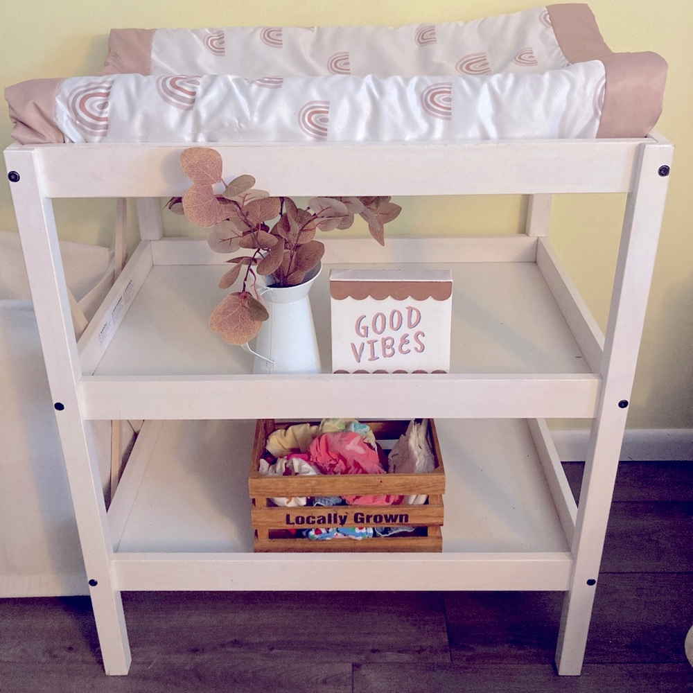 White changing table and changing pad.